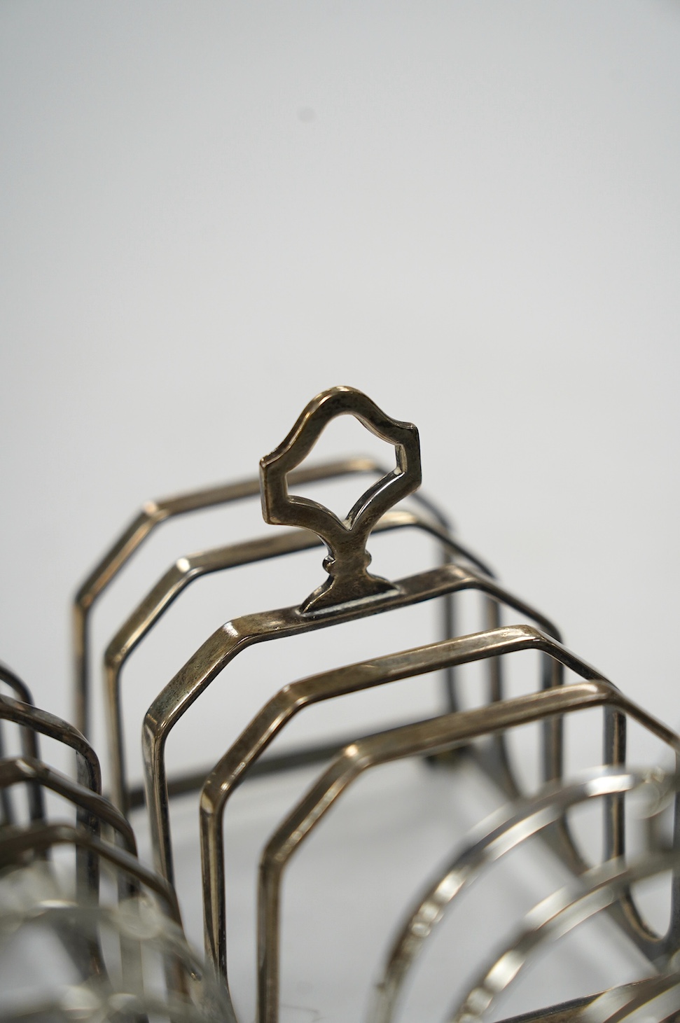 Two pairs of silver five bar toast racks, Birmingham, 1931 and Birmingham, 1932, 75mm, 10.7oz. Condition - fair